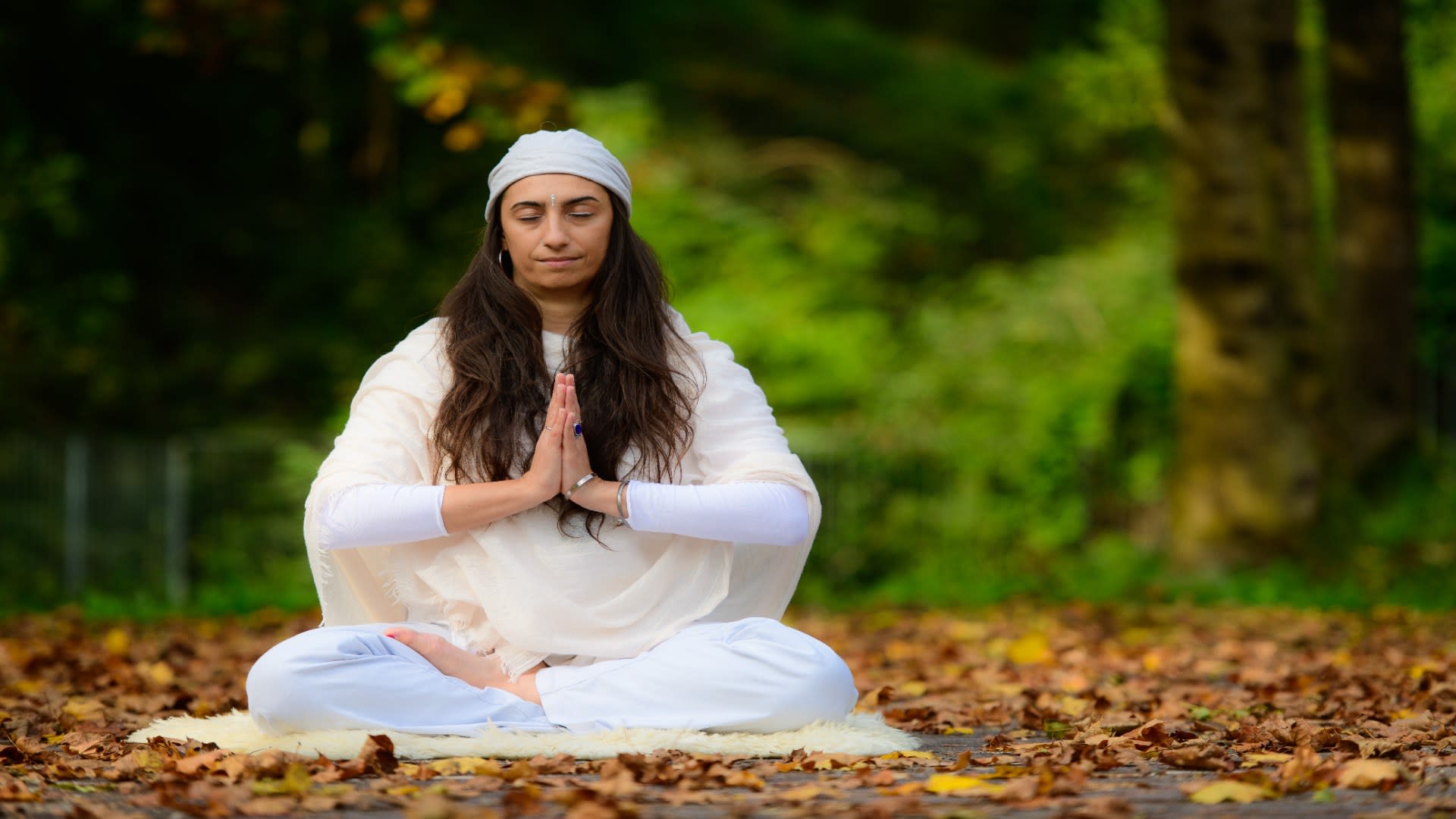 Woman meditating peacefully in nature, symbolizing mindfulness and emotional recovery as part of online substance abuse counseling.