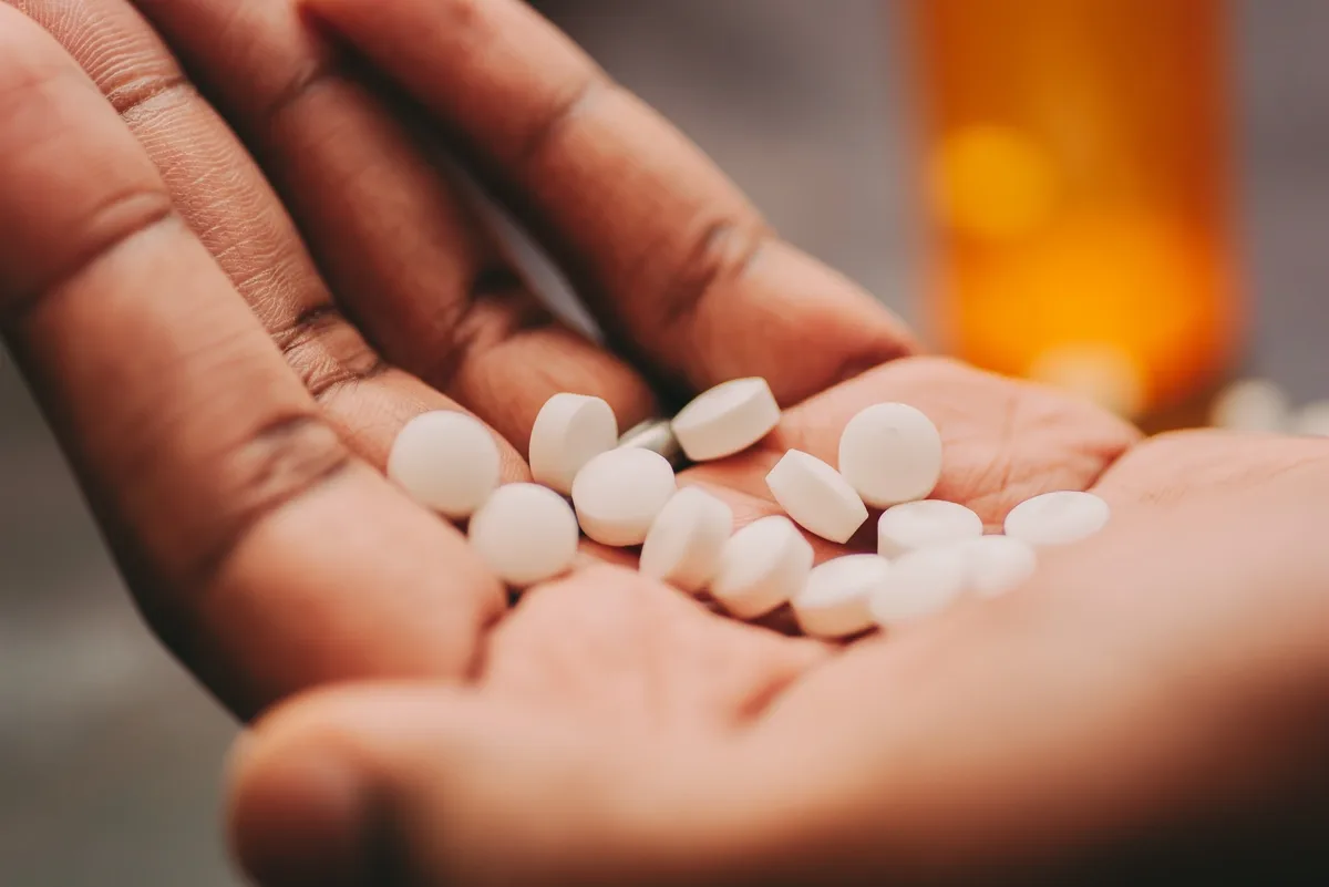 Opioid Addiction: Dozens of pills in the palm of a hand