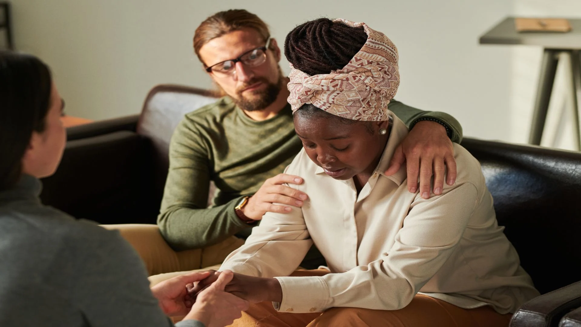 Relapse counseling in progress as a therapist supports a couple managing the emotional impact of addiction setbacks.