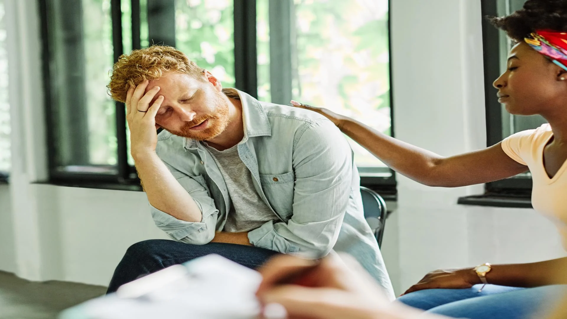 clonidine - man struggling with addiction withdrawal symptoms talking in therapy session