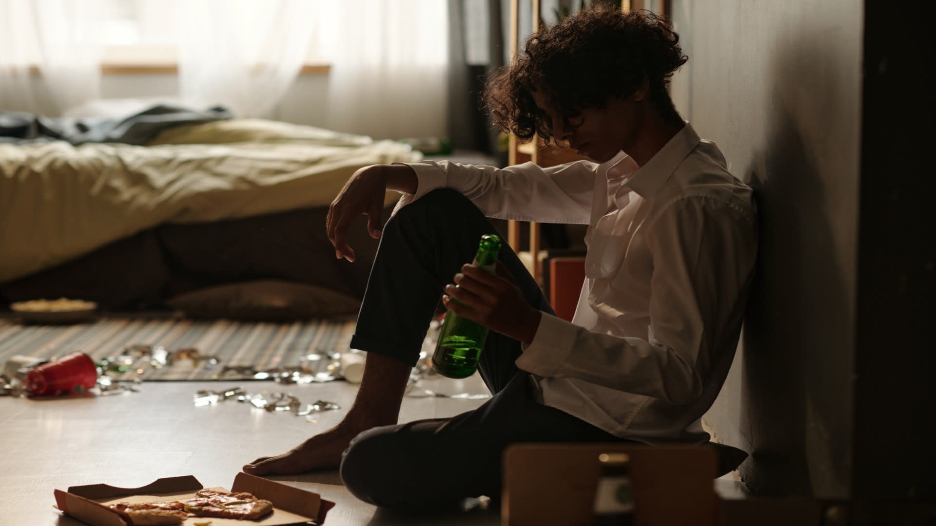 guy-with-bottle-of-beer-sitting-by-wall-2025-03-18-04-07-40-utc