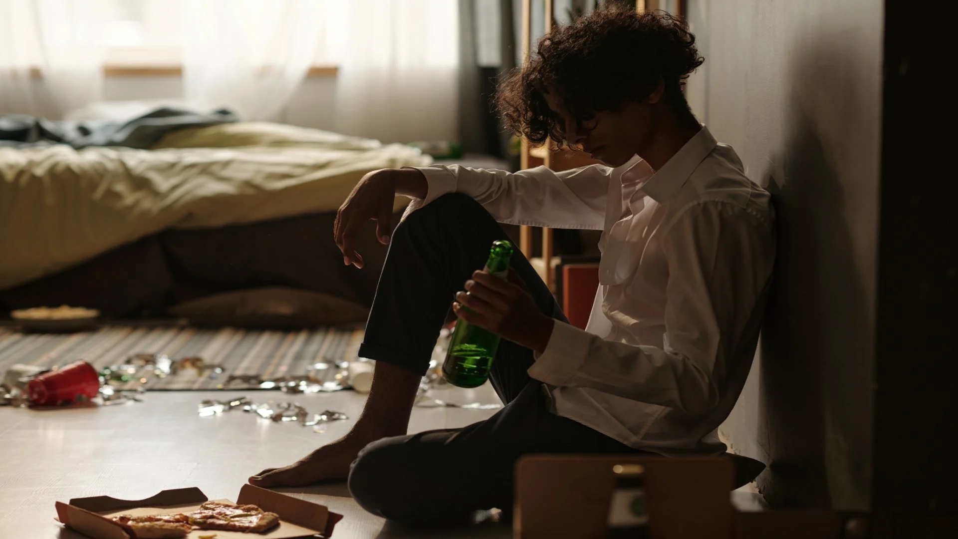 guy-with-bottle-of-beer-sitting-by-wall-2025-03-18-04-07-40-utc