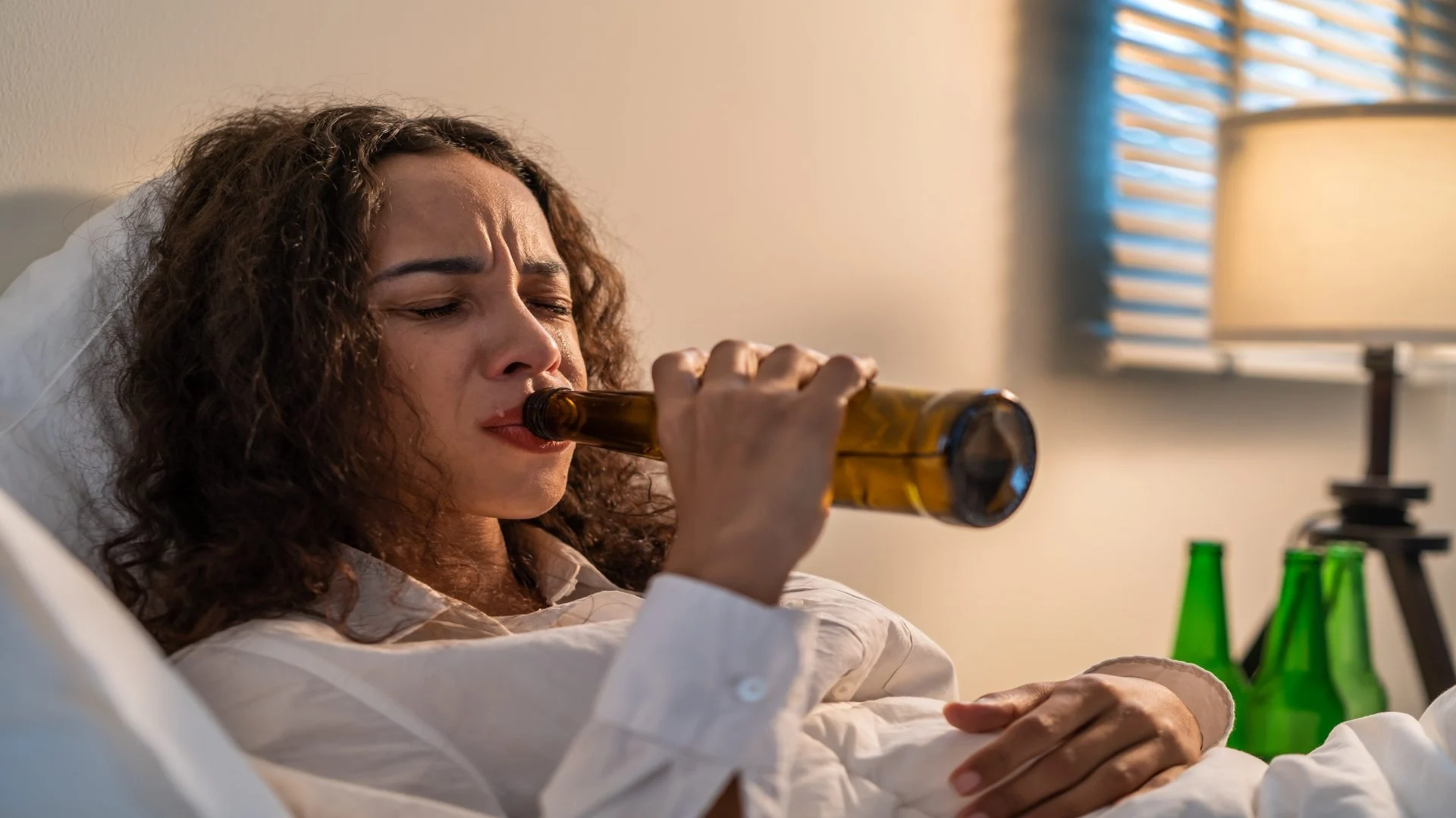 drunk-latino-woman-hold-beer-bottle-and-crying-fe-2025-04-02-21-54-46-utc