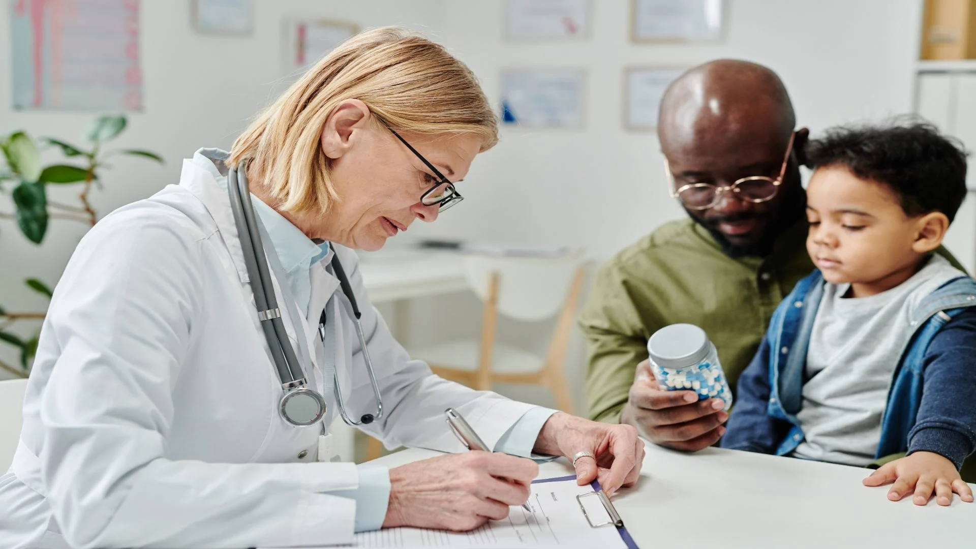 a clinician filling a medical form while her patients looks at the difference between pregabalin and gabapentin.