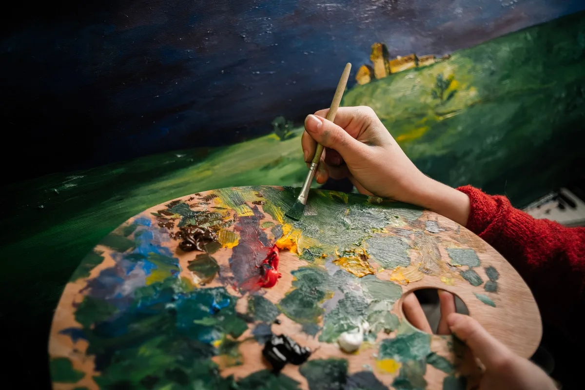 Experiential Therapy: Person mixing paints on a palette