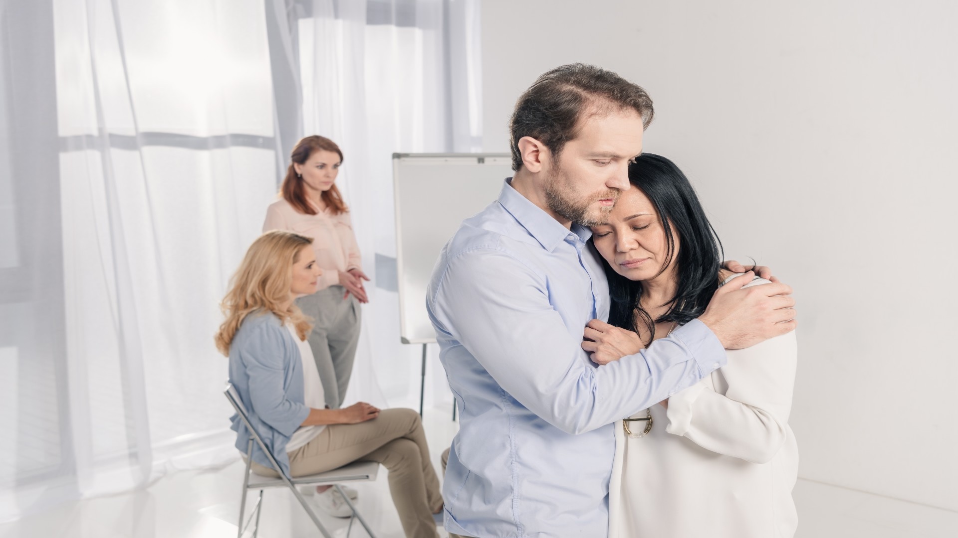 mature-man-hugging-depressed-asian-woman-during-gr-2024-11-19-18-30-06-utc