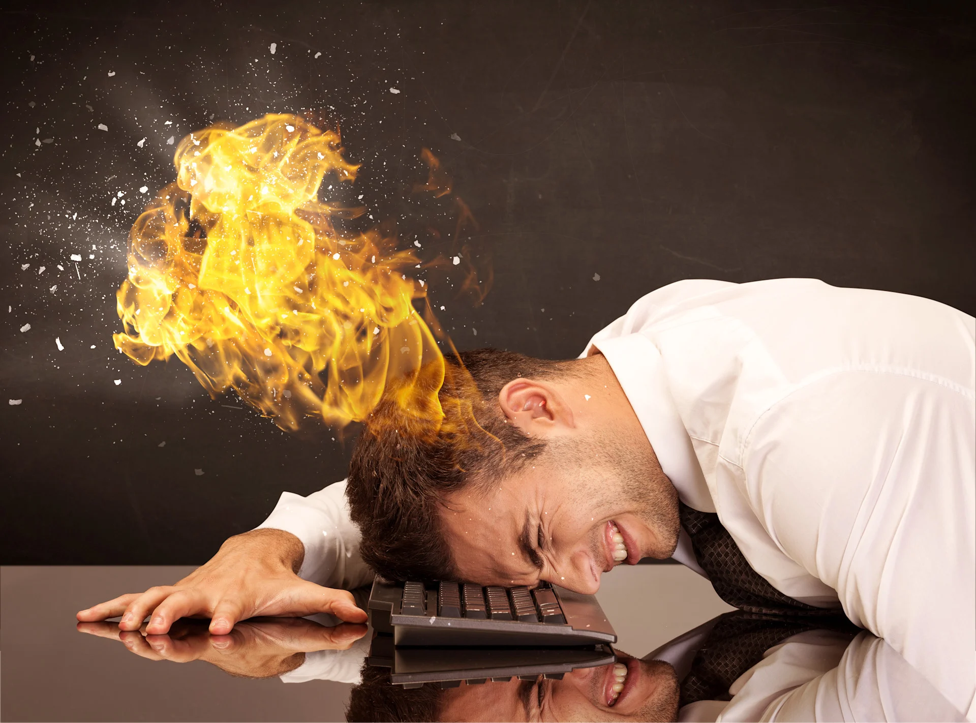 Visual representation of burnout symptoms showing overwhelmed professional at computer