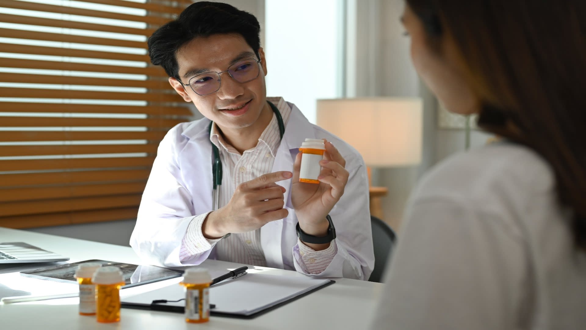 smiling-doctor-explaining-medicine-dosage-to-o-pat-2024-12-05-16-35-05-utc