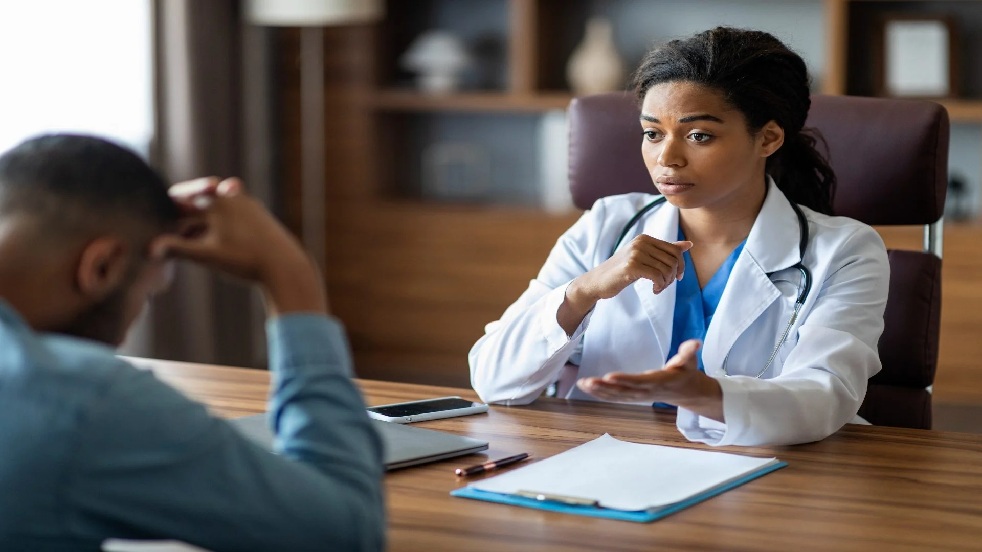 black-woman-doctor-having-conversation-with-upset-2025-03-18-17-31-56-utc