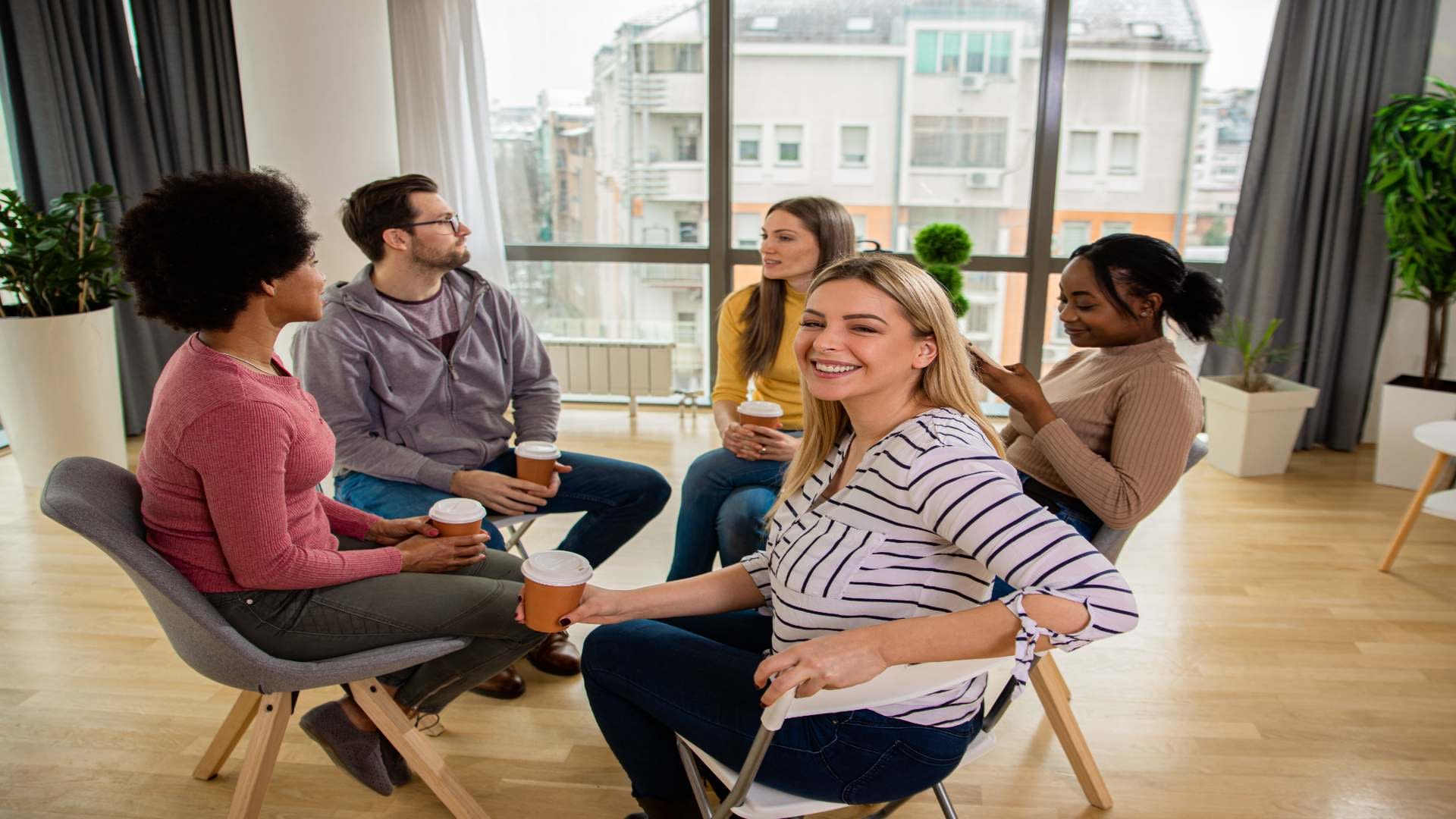 diverse-group-of-people-sitting-in-circle-in-group-2025-02-11-14-58-31-utc