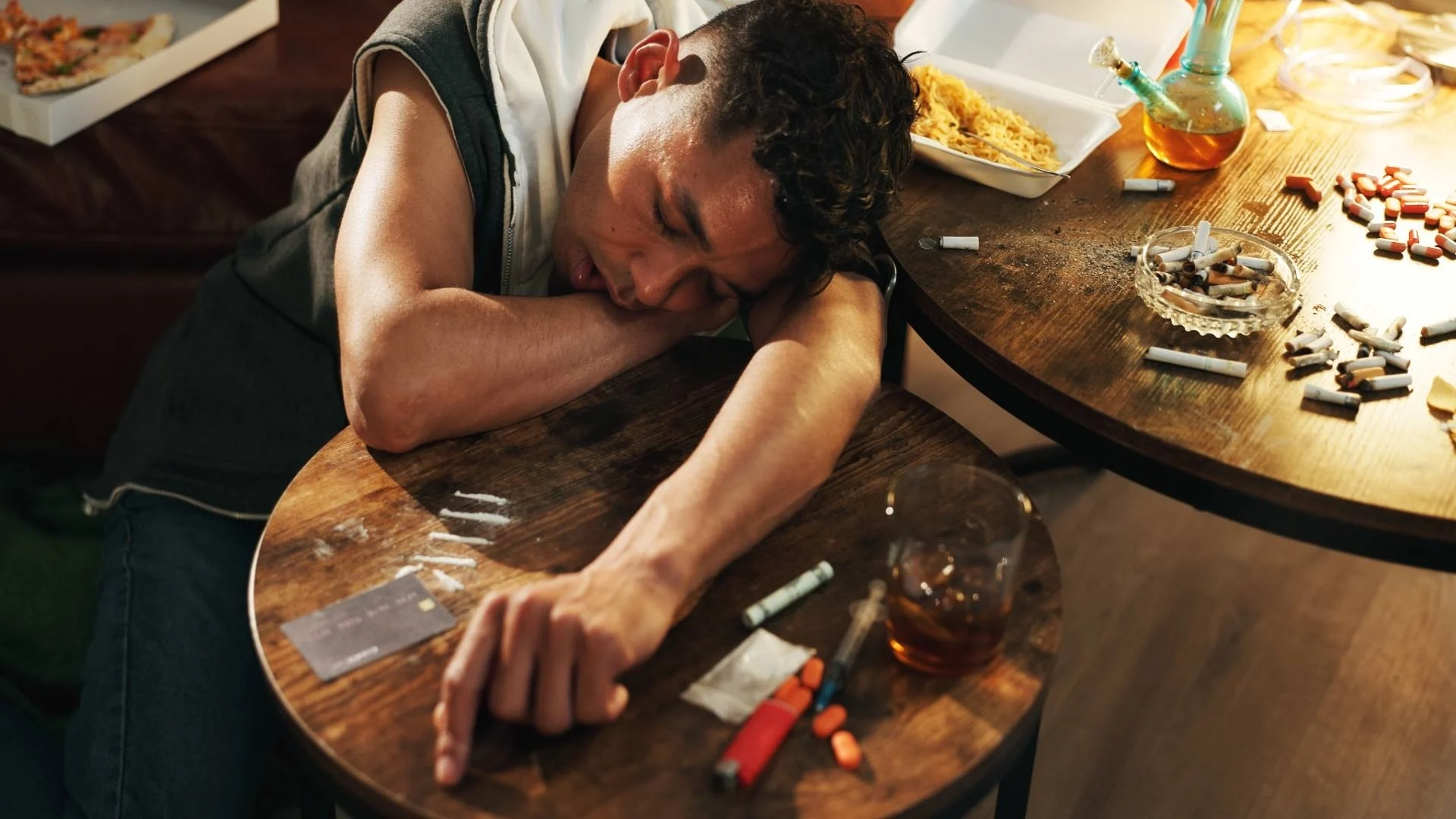 drugs-overdose-and-man-with-face-on-table-health-2025-04-05-17-59-10-utc