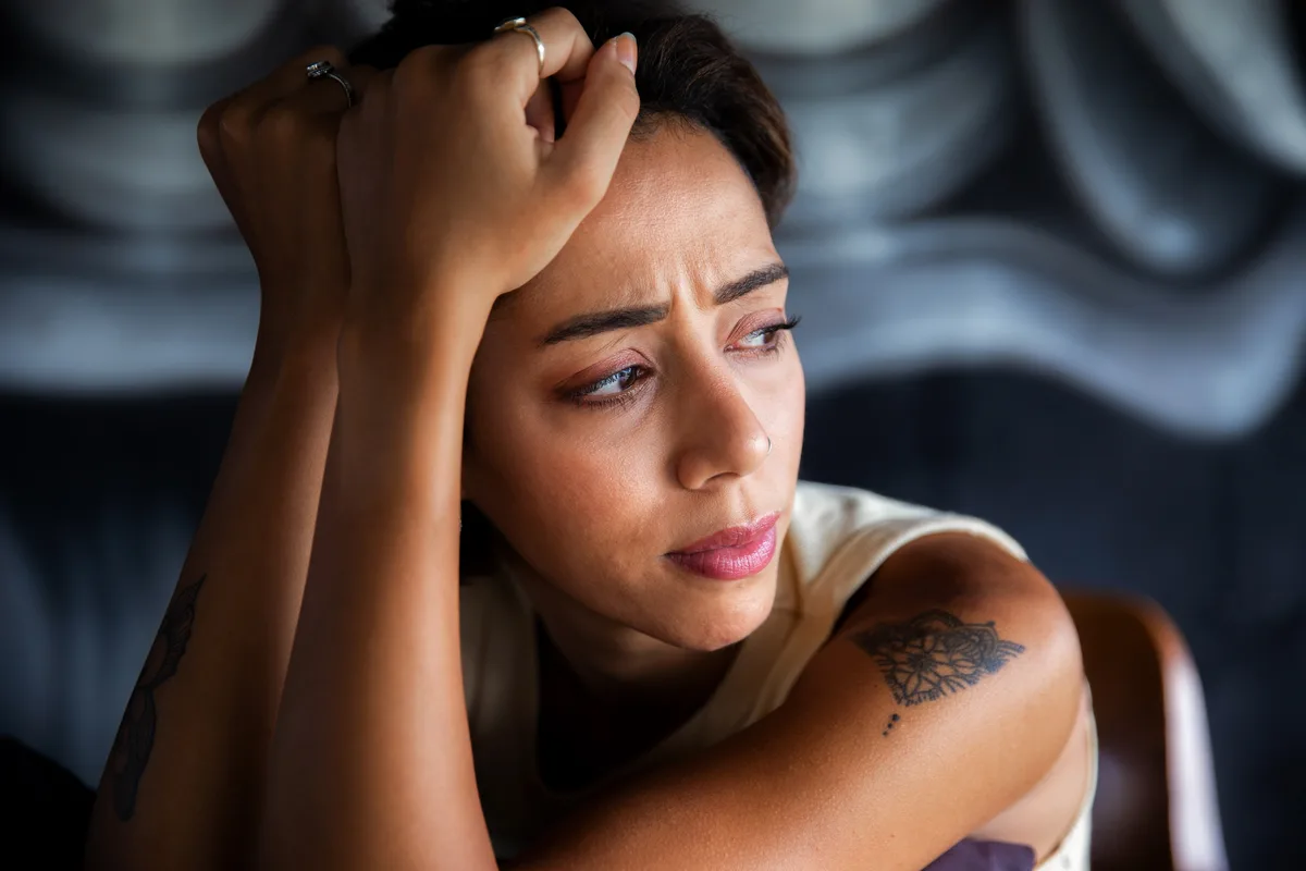 Synthetic Drug Addiction: Tattoo'd Woman looking concerned