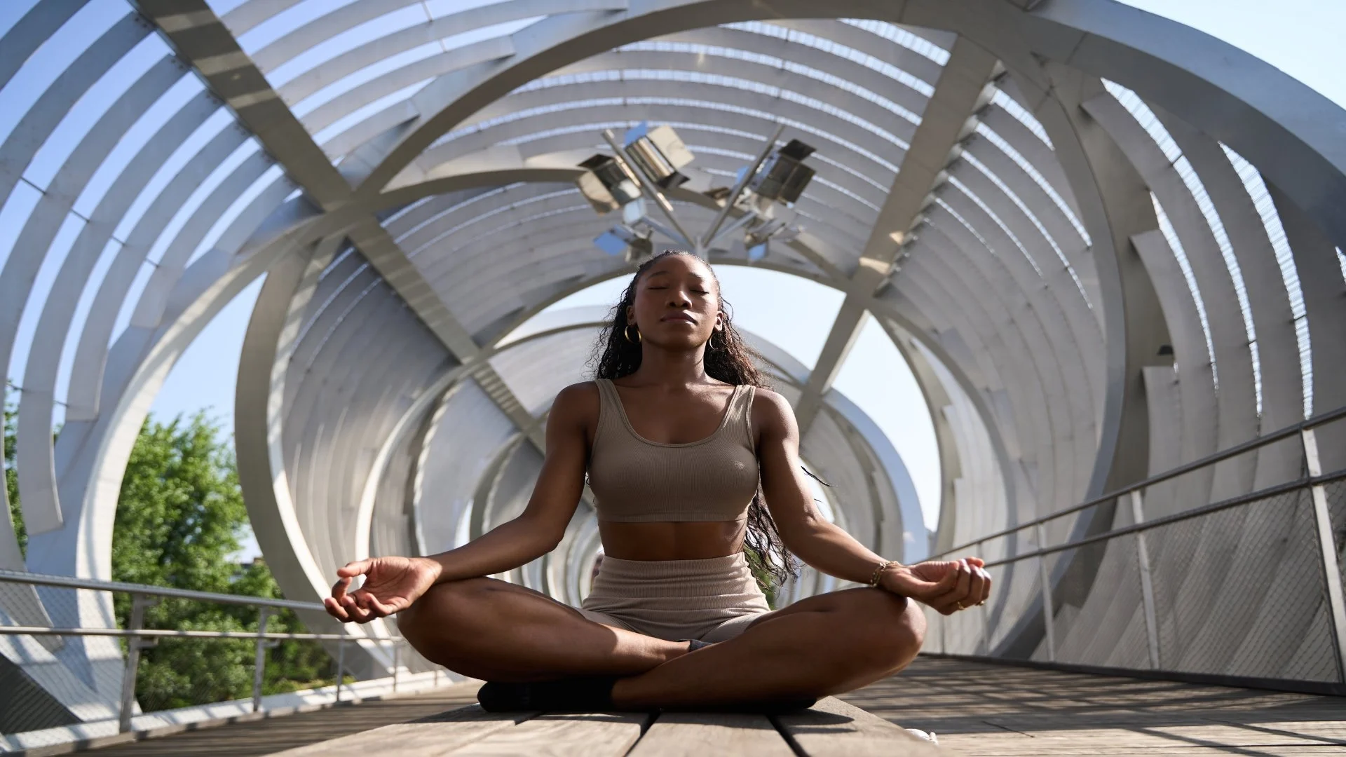 young-woman-meditating-in-lotus-position-on-modern-2025-08-10-17-16-44-utc