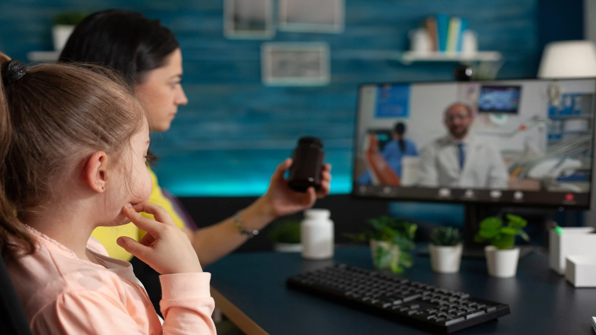 Mother and young daughter attending a telehealth session for behavioral health concerns, speaking with a pediatric provider via video call.