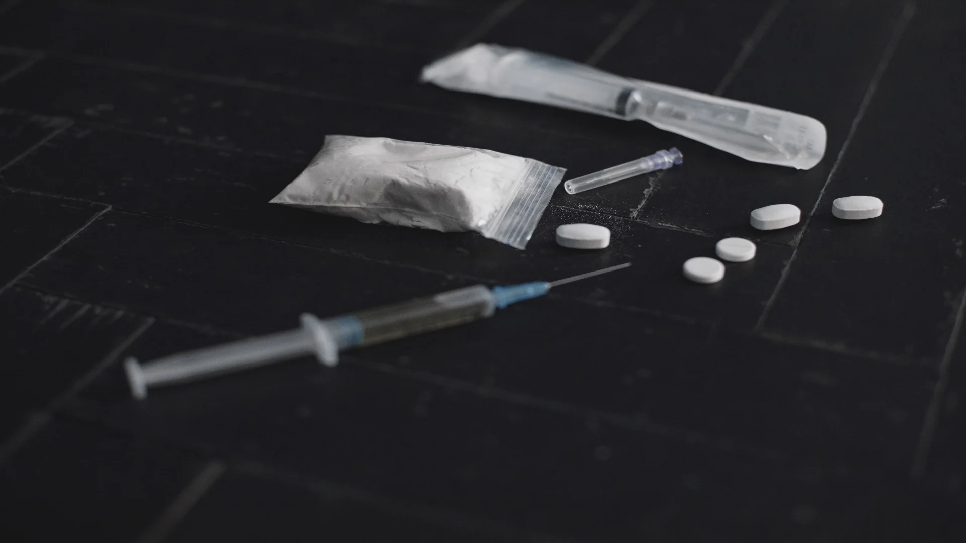 syringe-and-pills-on-dark-background-close-up-2024-12-07-00-27-59-utc