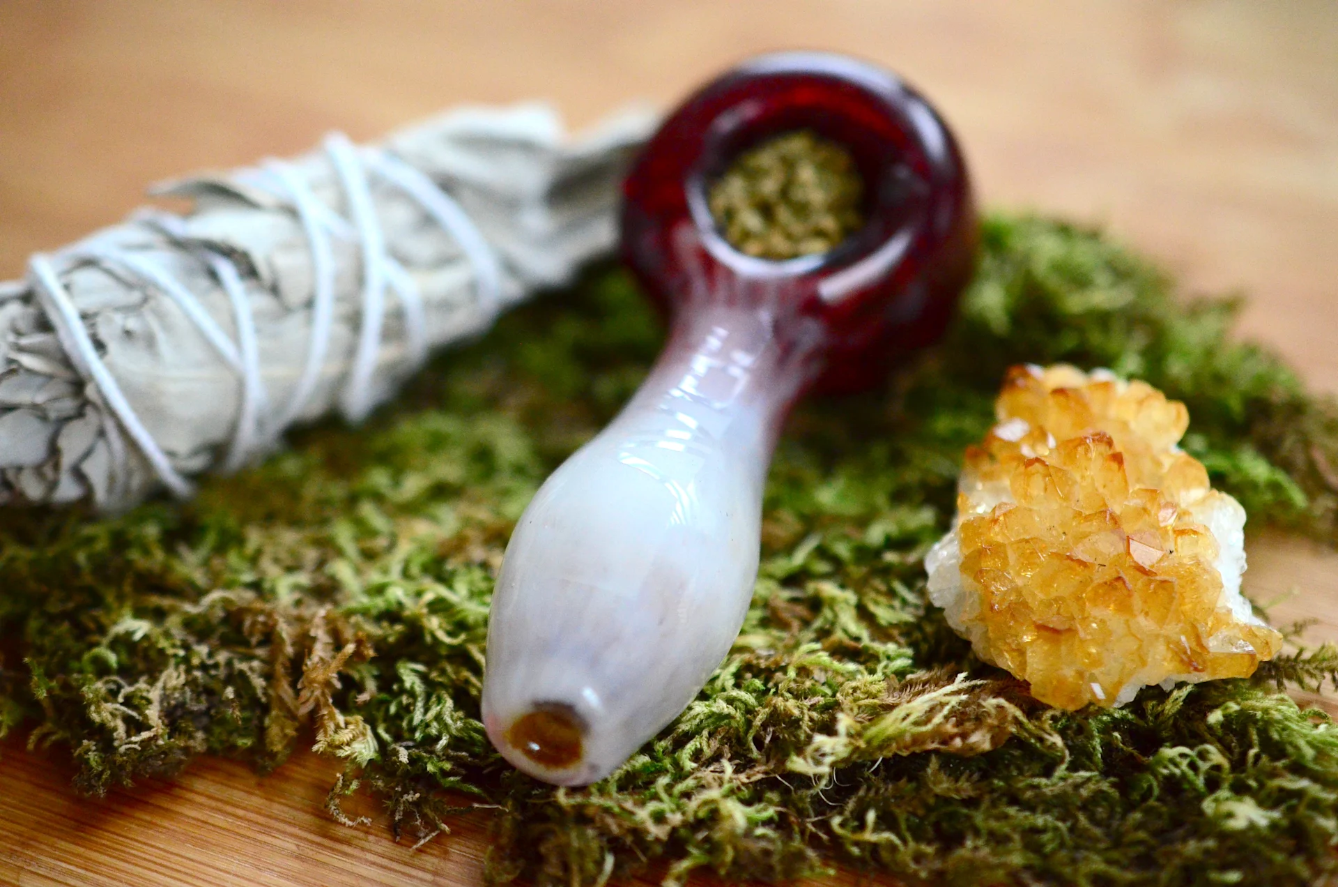 marijuana pipe sitting on weed and stuffed full of cannabis ready to be used and smoked