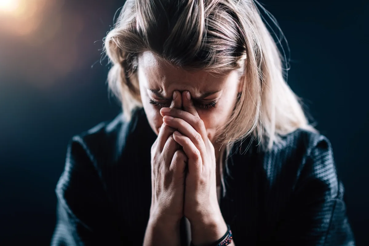 Woman with Generalized Anxiety Disorder Frowning in the Dark
