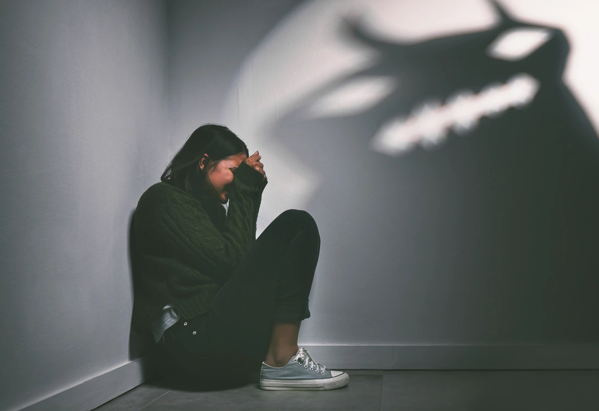 Woman Sitting on Floor Scared of Shadows