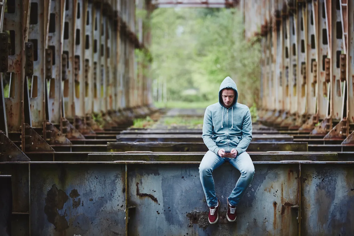 Seasonal Affective Disorder Man Sitting in Industrial Area