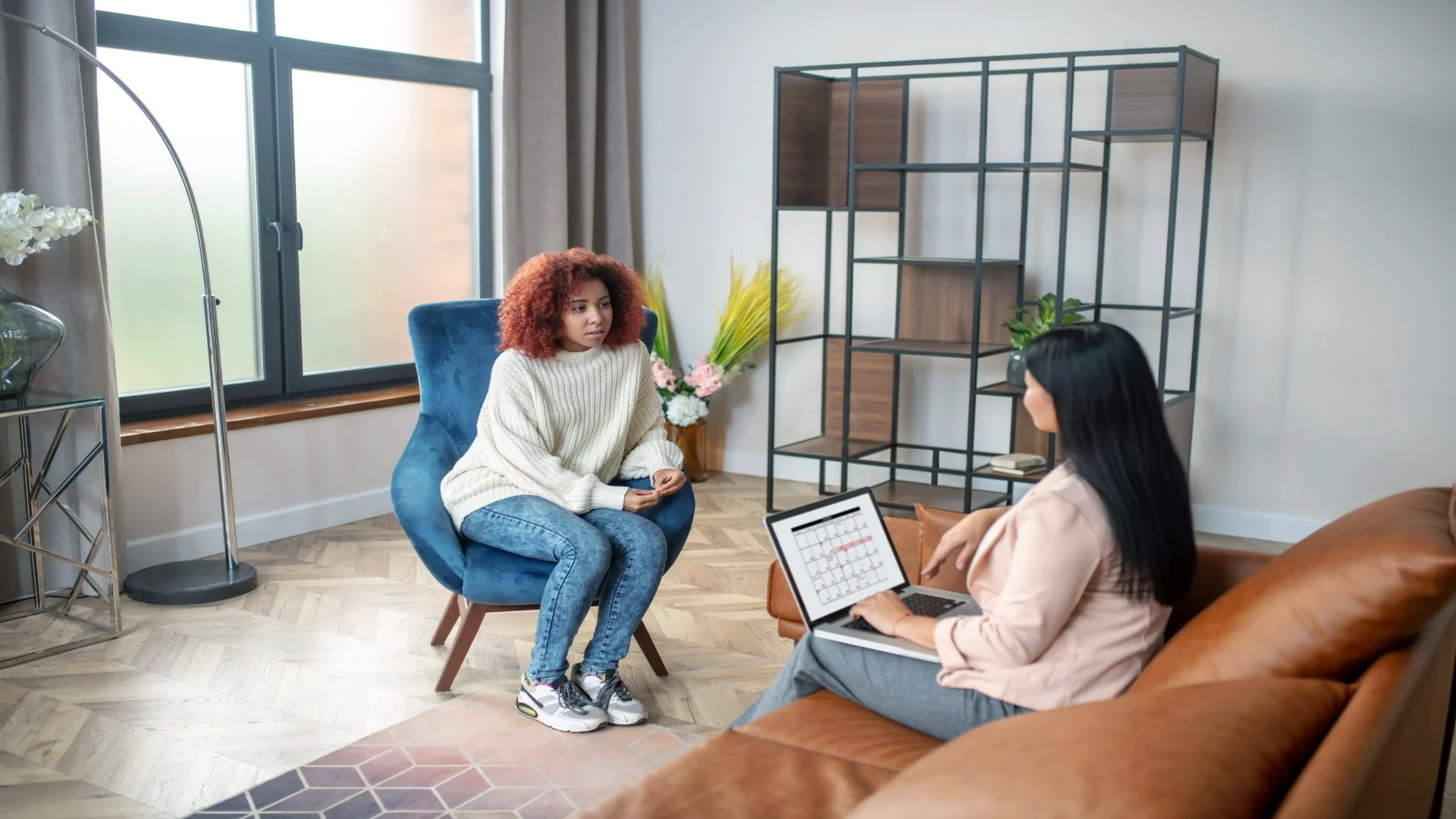 Therapist and client discussing emotional concerns in a cozy office setting, representing the transition to online mental health counseling options.