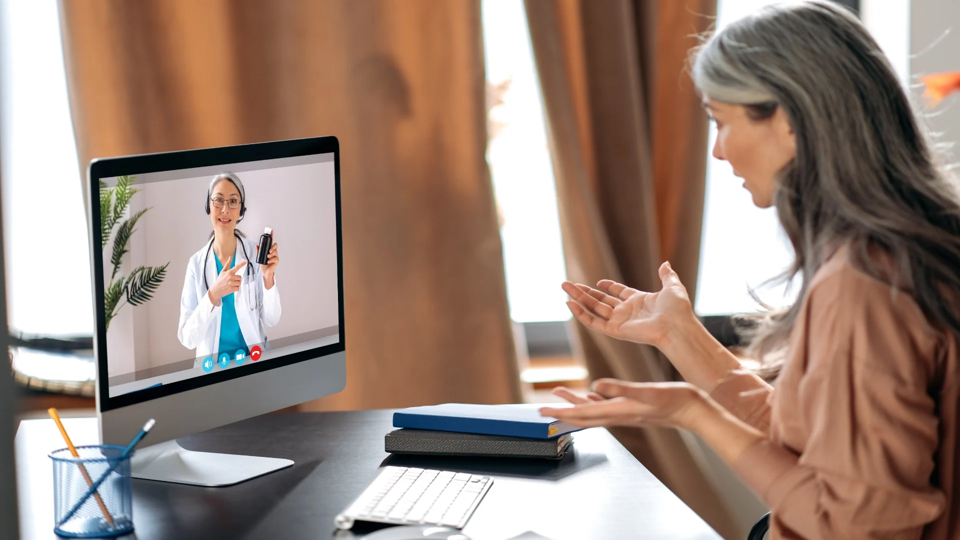 Mature woman in an online substance abuse counseling session, talking to a doctor about prescription treatment options via video. Mature woman in an online substance abuse counseling session, talking to a doctor about prescription treatment options via video.