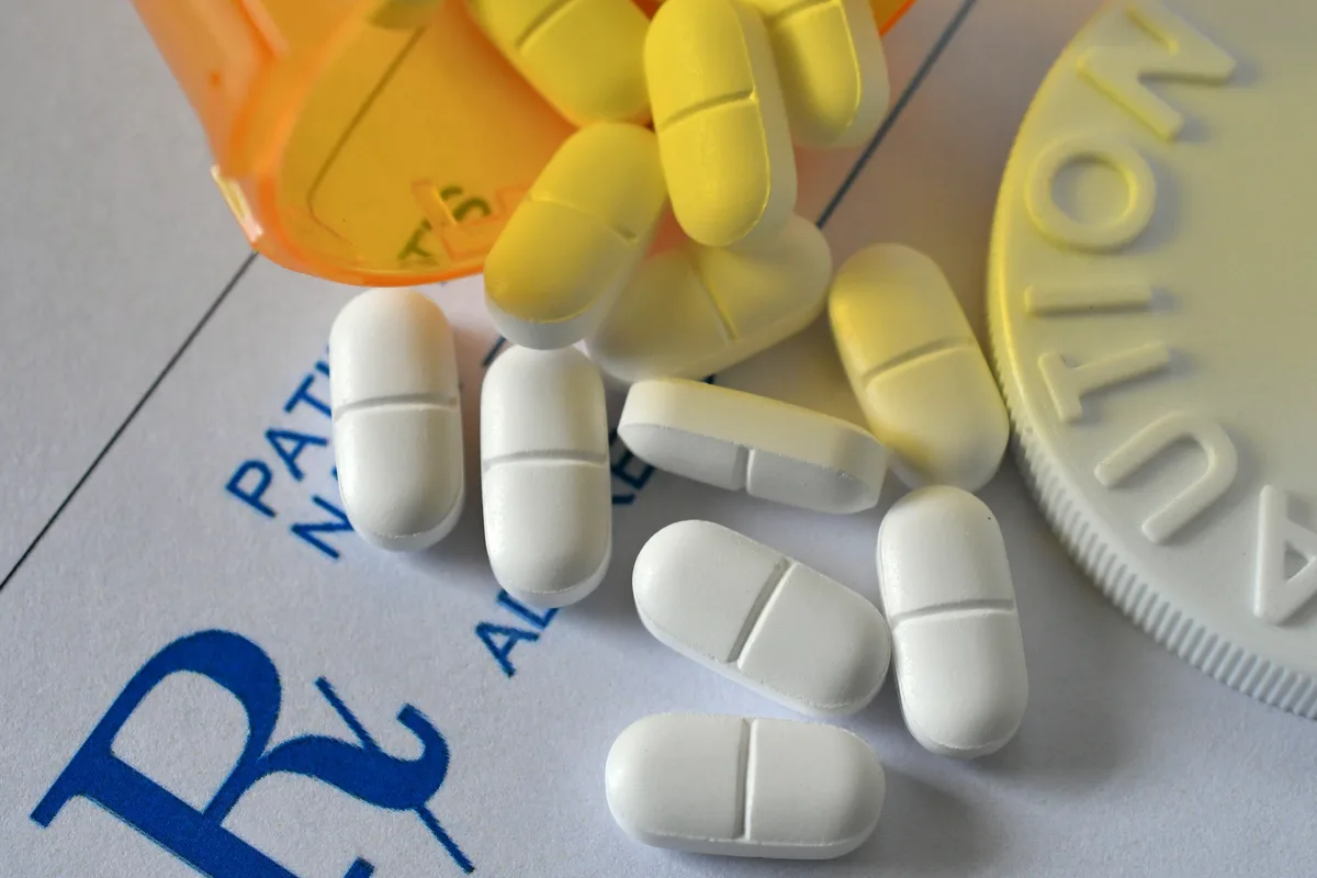 Prescription Drug Addiction: Close up of prescription drugs spilled from a pill bottle. Prescription Drug Addiction: Close up of prescription drugs spilled from a pill bottle.