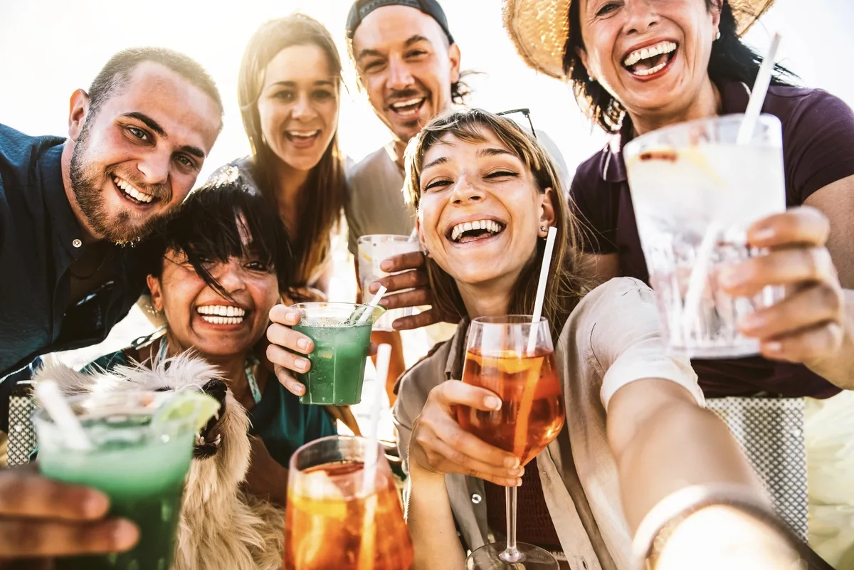 Alcohol Addiction: People taking a picture with drinks in hand