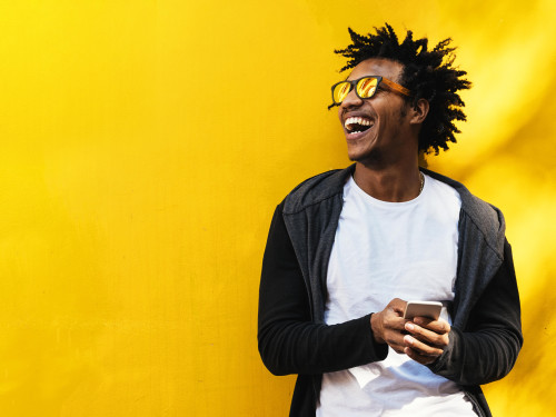 Man smiling on bright yellow background