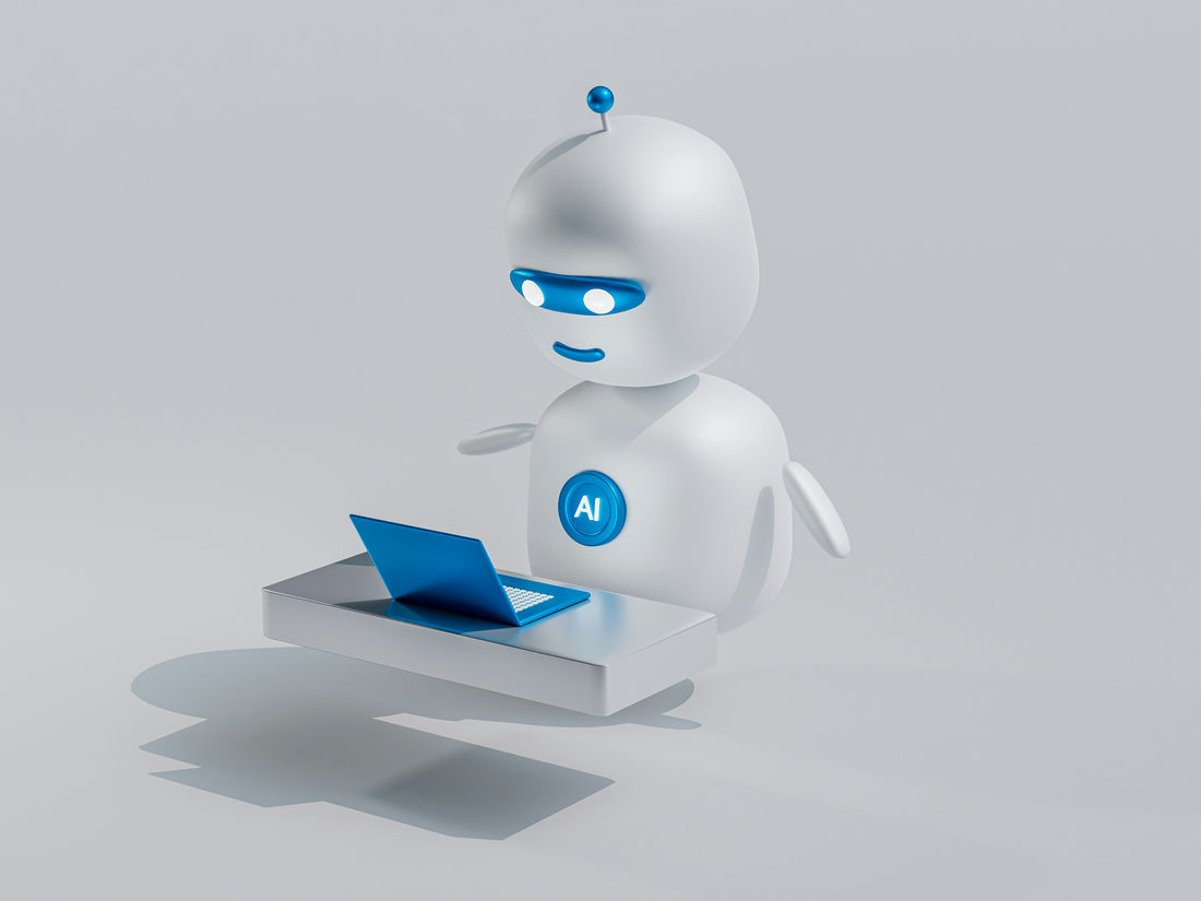 AI in HR - Illustrative robot sat at laptop
