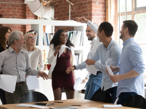 How to improve employee engagement - Employees gathered together engaging with one another