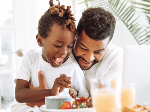 A man and a child eating food
