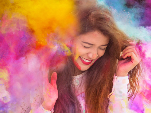 Person surrounded by colourful clouds