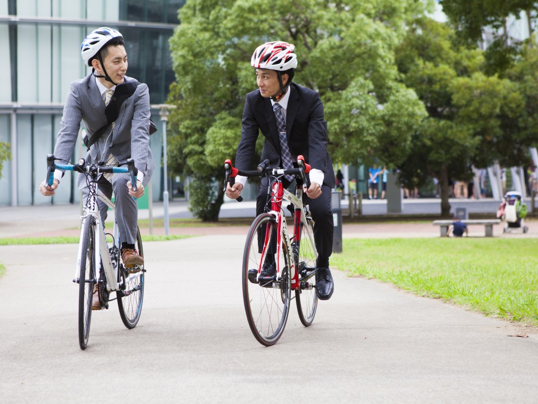 Two men commuting to work on bicycles