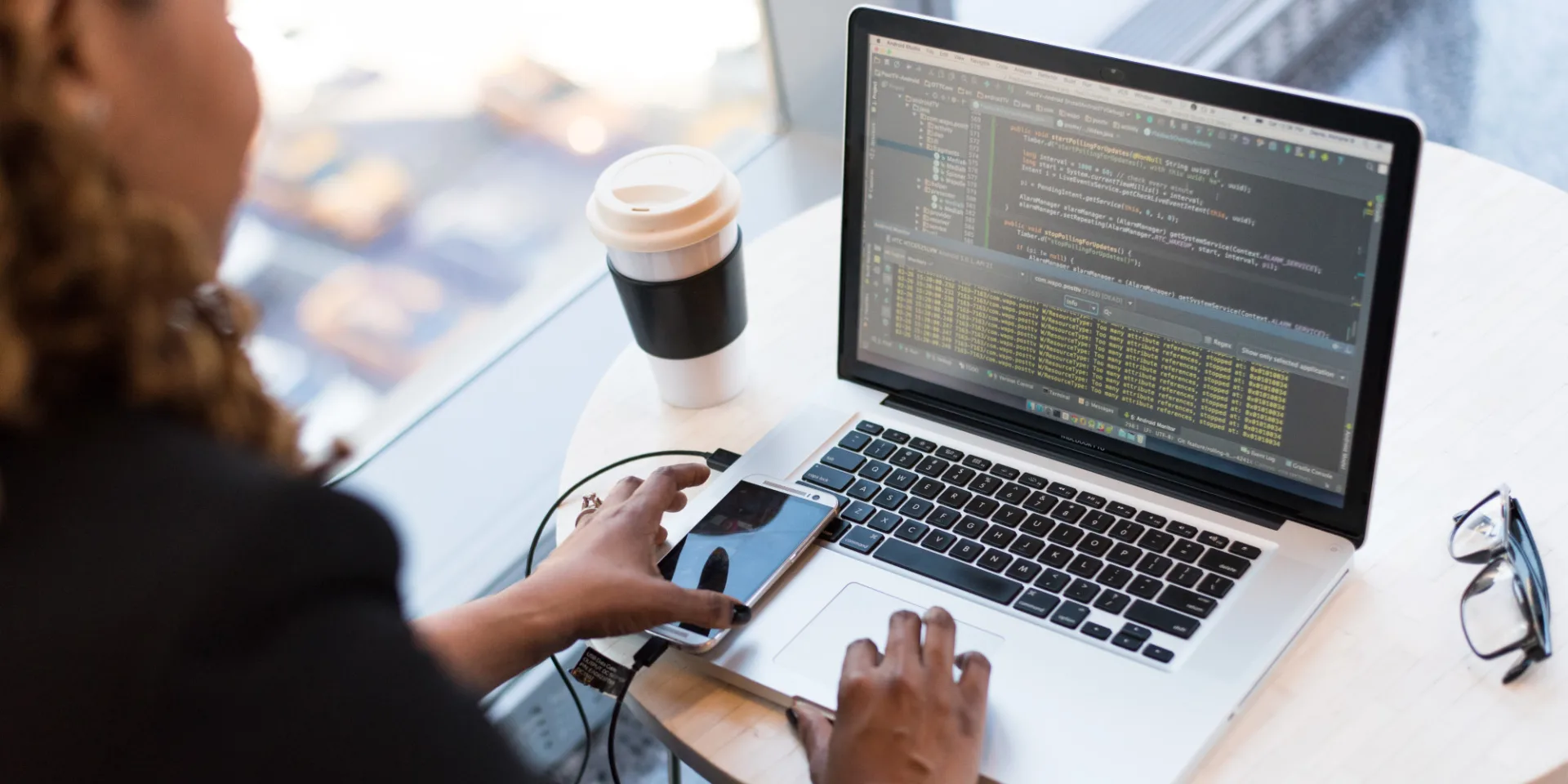 Woman in front of laptop coding.