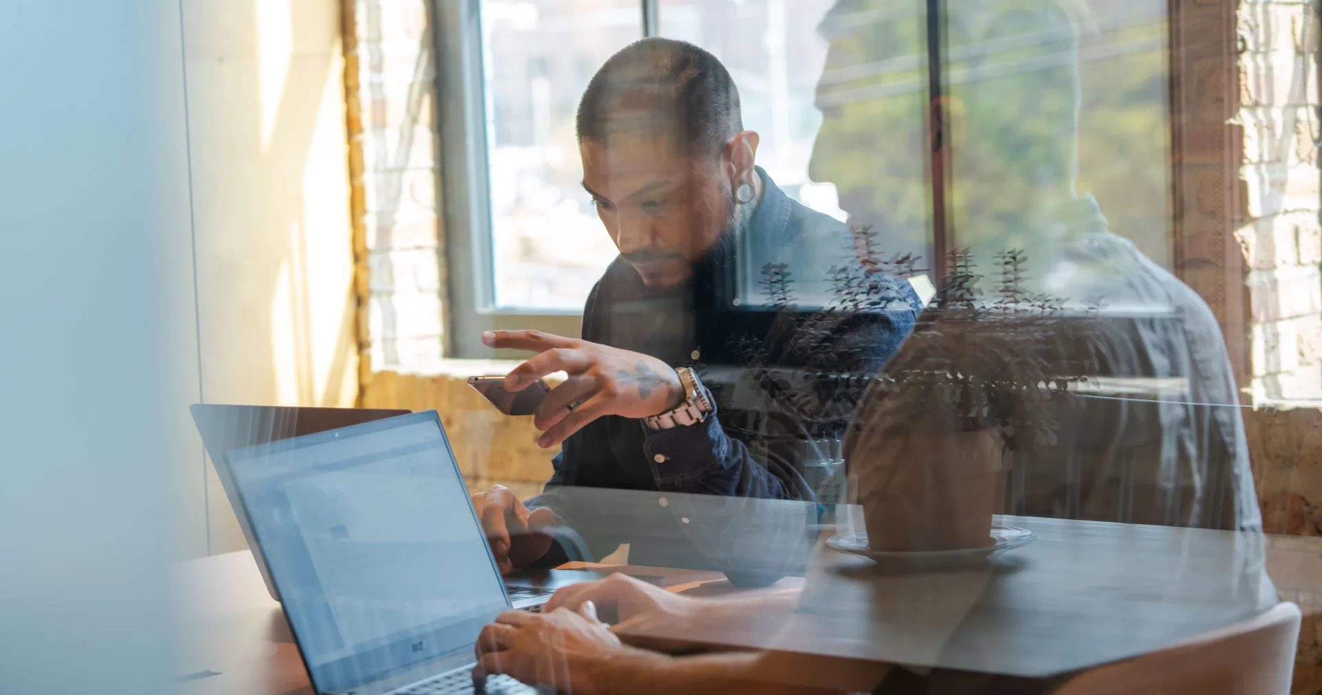 Two people in a conference room at computers