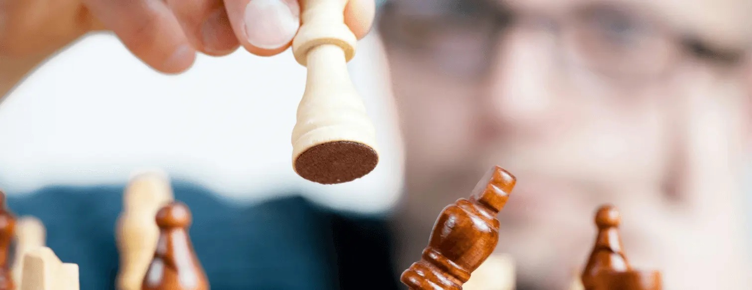 Player moving a chess piece on a chess board