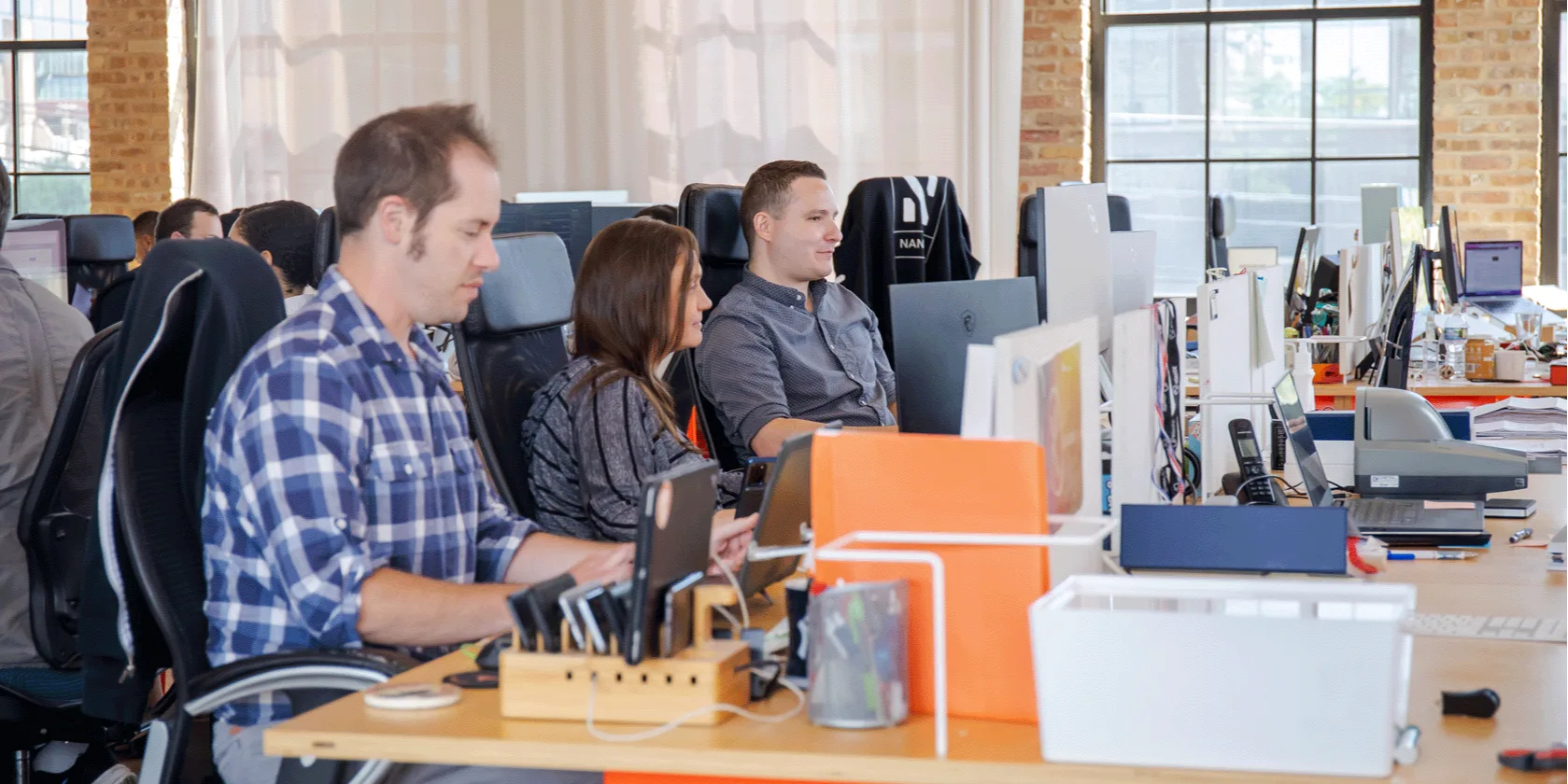 Three people sitting in the Nansen open concept office.