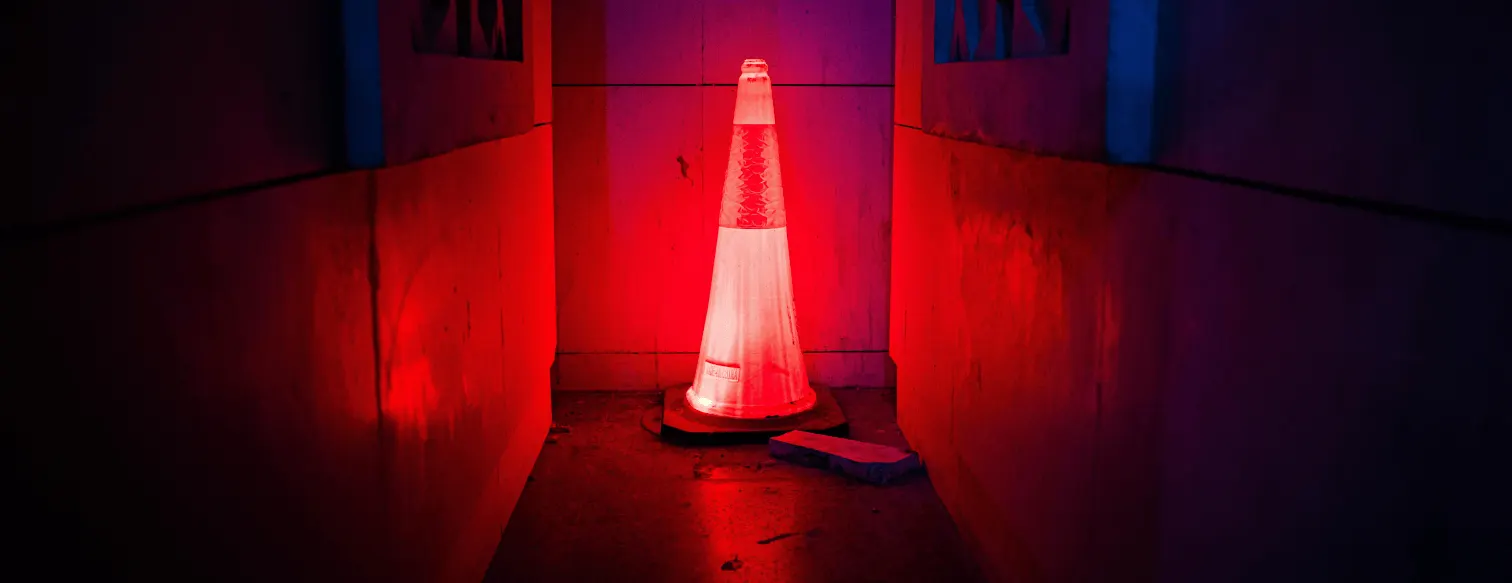 glowing traffic cone at the end of a dark tunnel