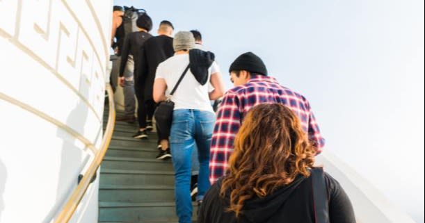 People standing in a queue on a flight of stairs.