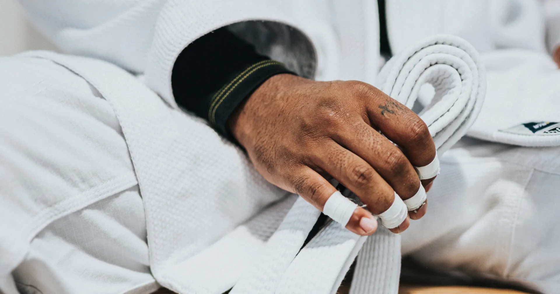 image of someone in martial arts uniform holding a white belt