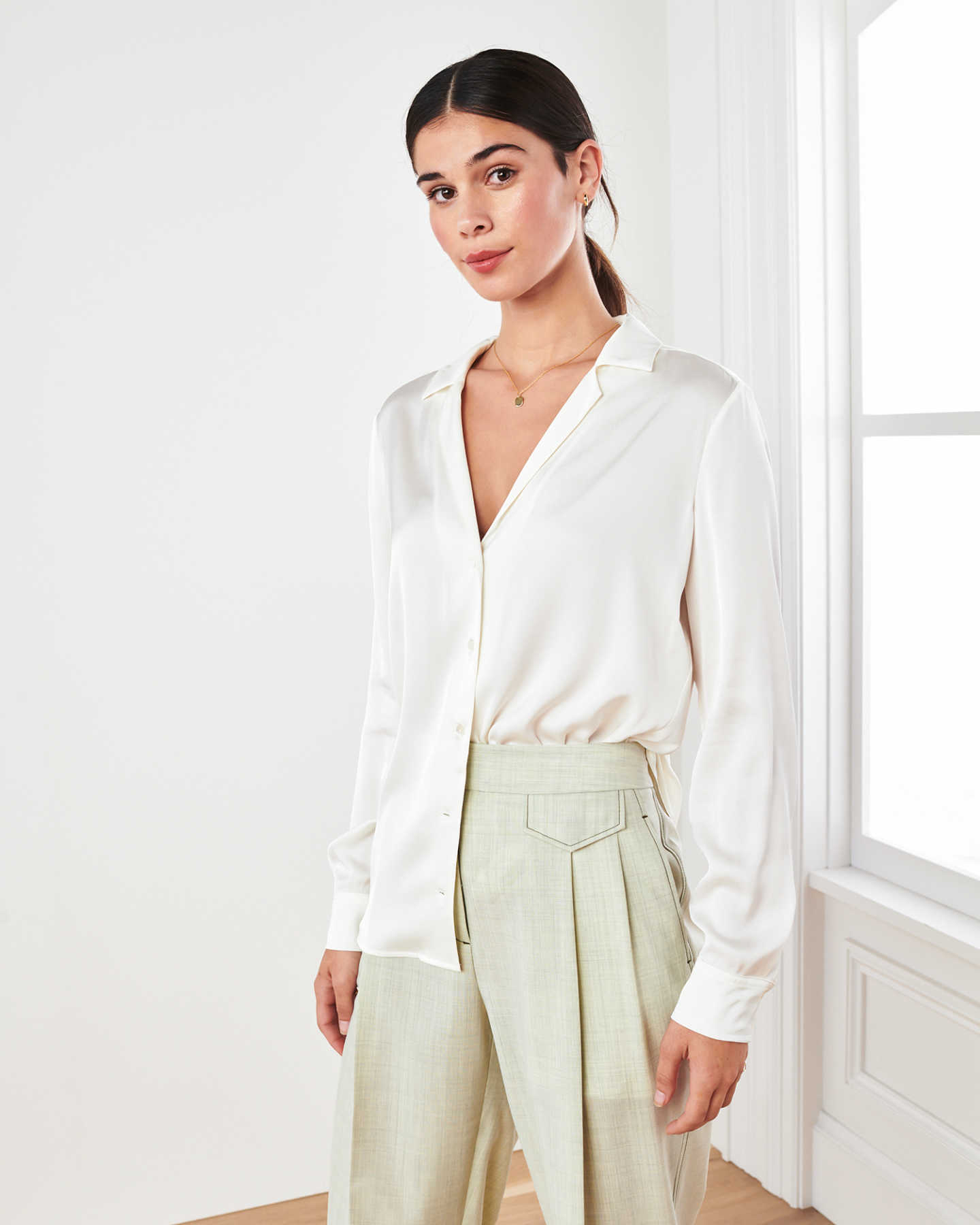 woman wearing silk notch collar blouse in ivory