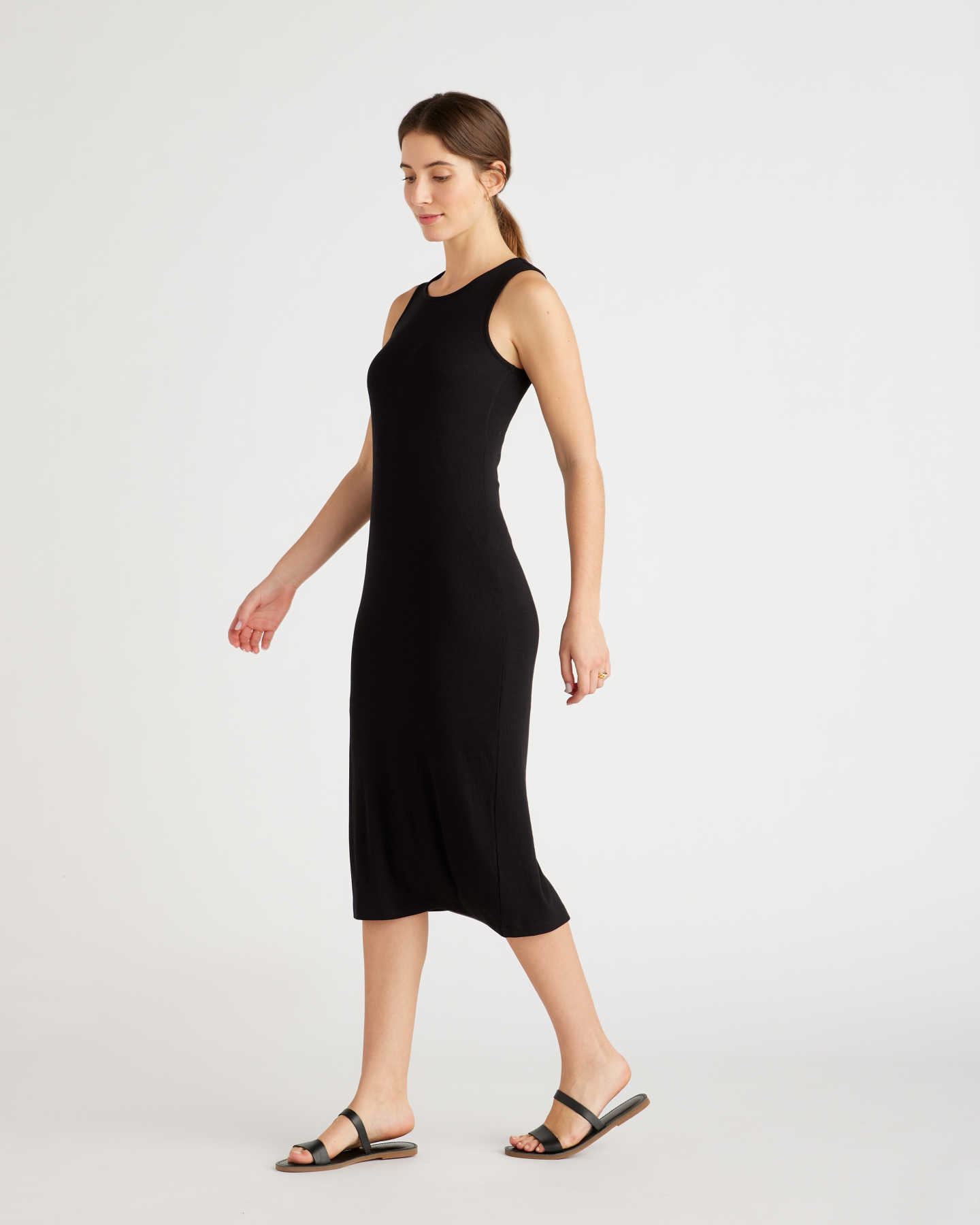 Woman wearing a rib knit dress in black walking
