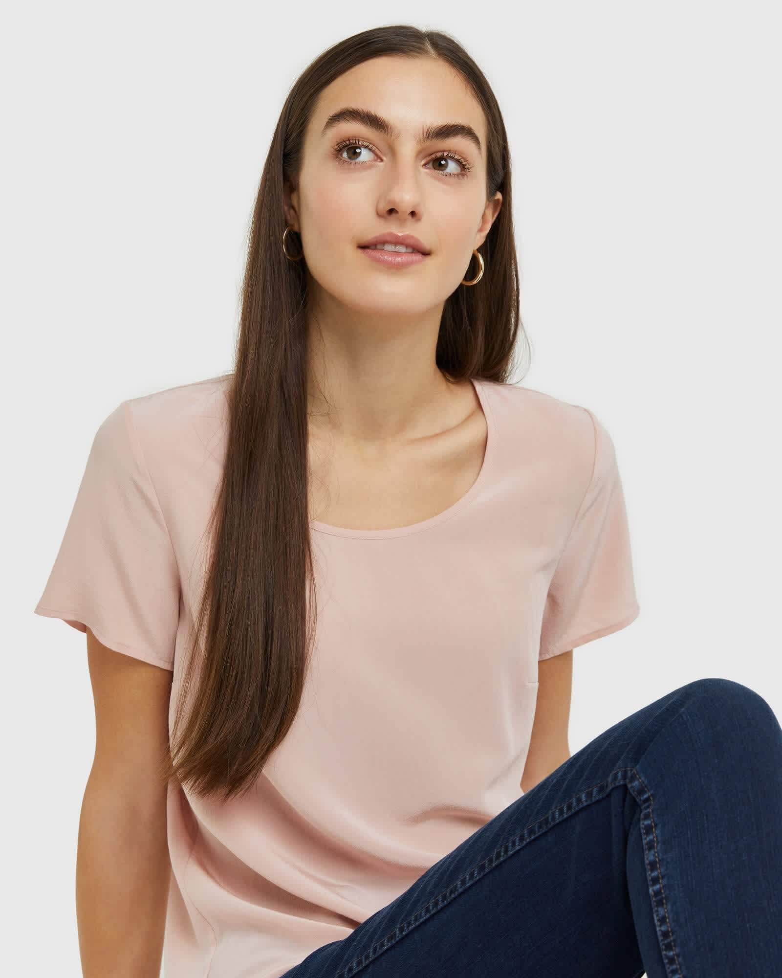 Woman wearing silk tee in pink smiling