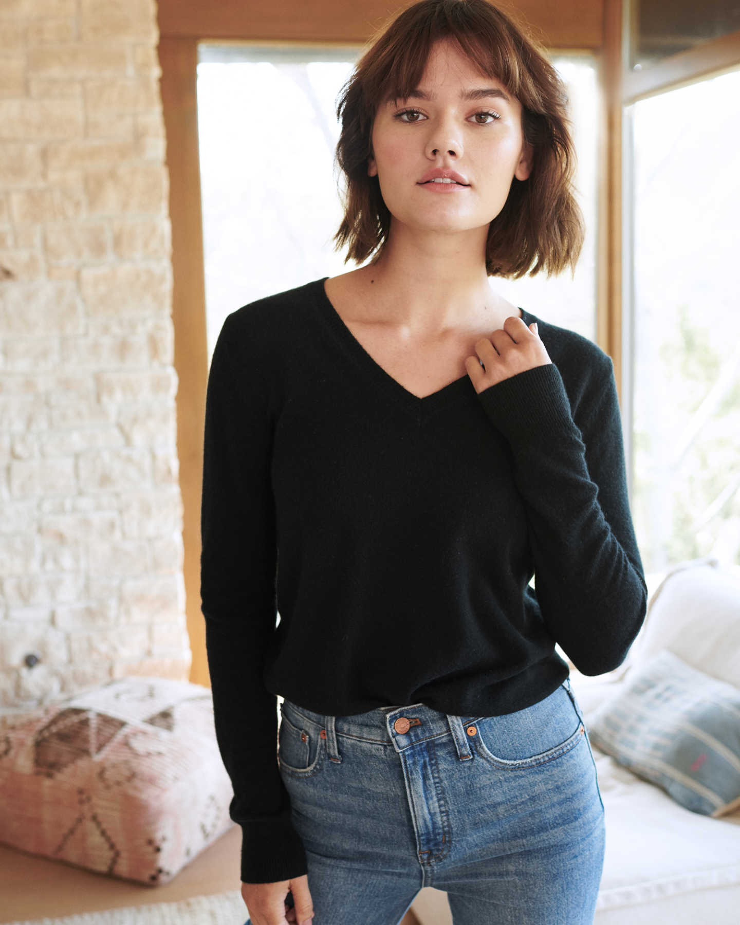 black cashmere v-neck sweater for women smiling