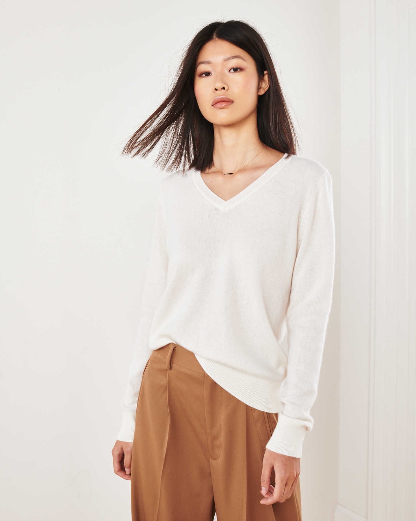 ivory cashmere v-neck sweater women standing