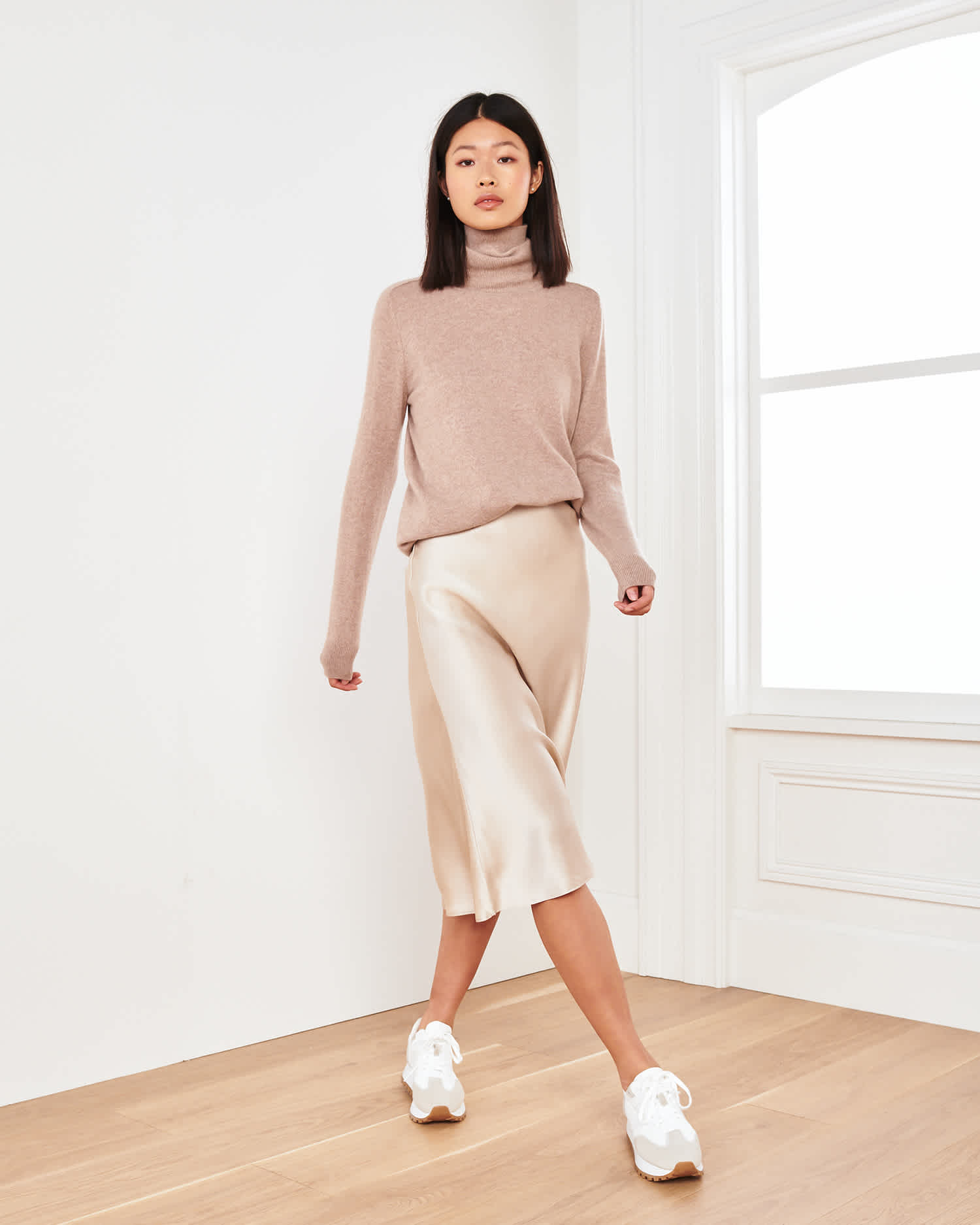 Woman wearing champagne silk skirt