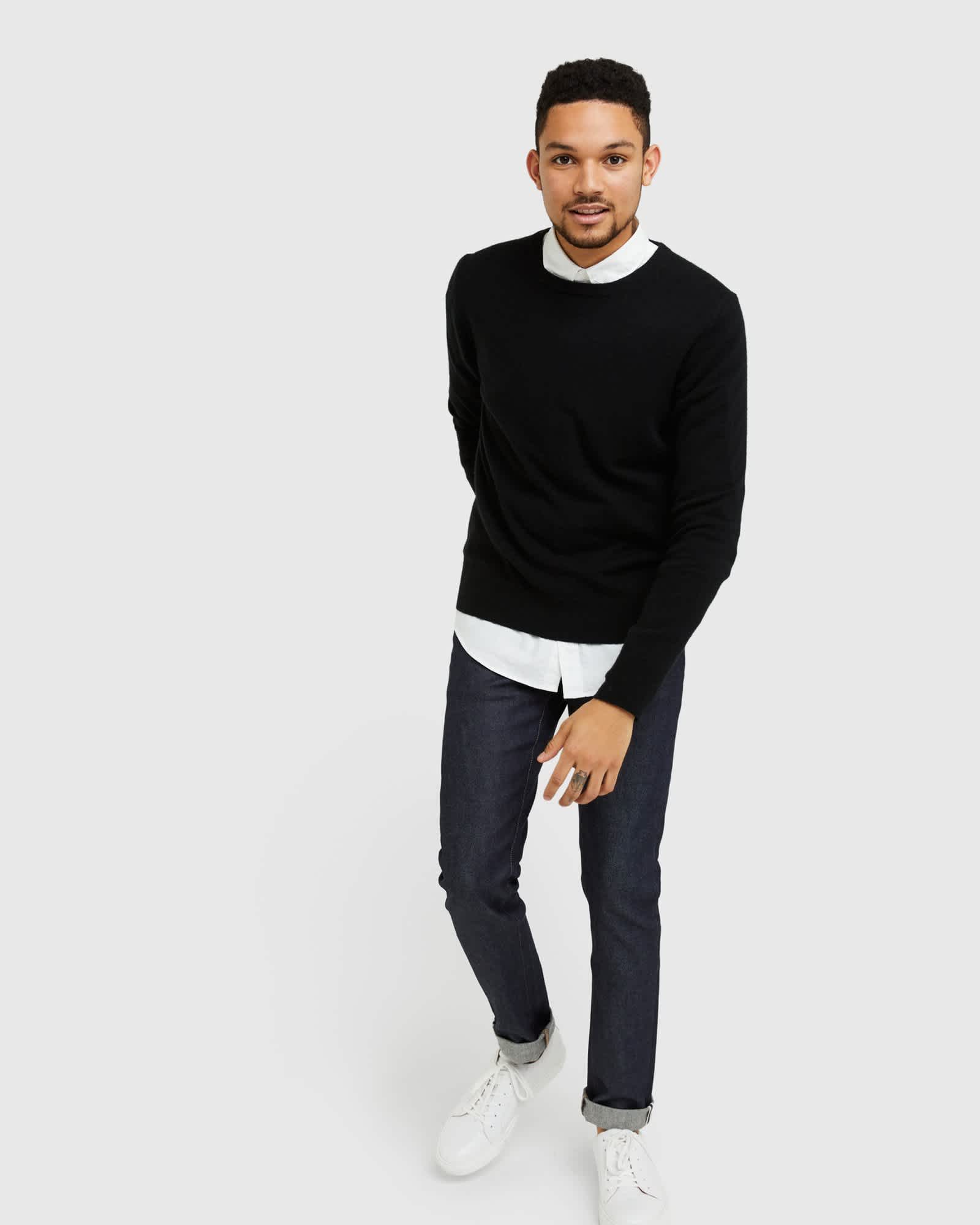 Man wearing black men's cashmere sweater walking