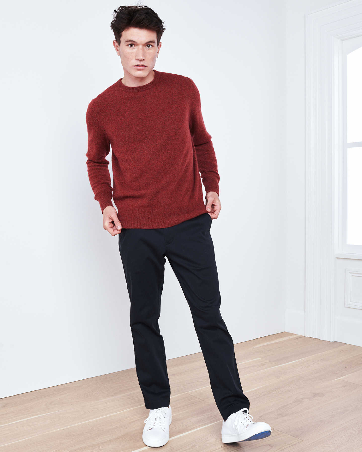 Man wearing red men's cashmere sweater by window