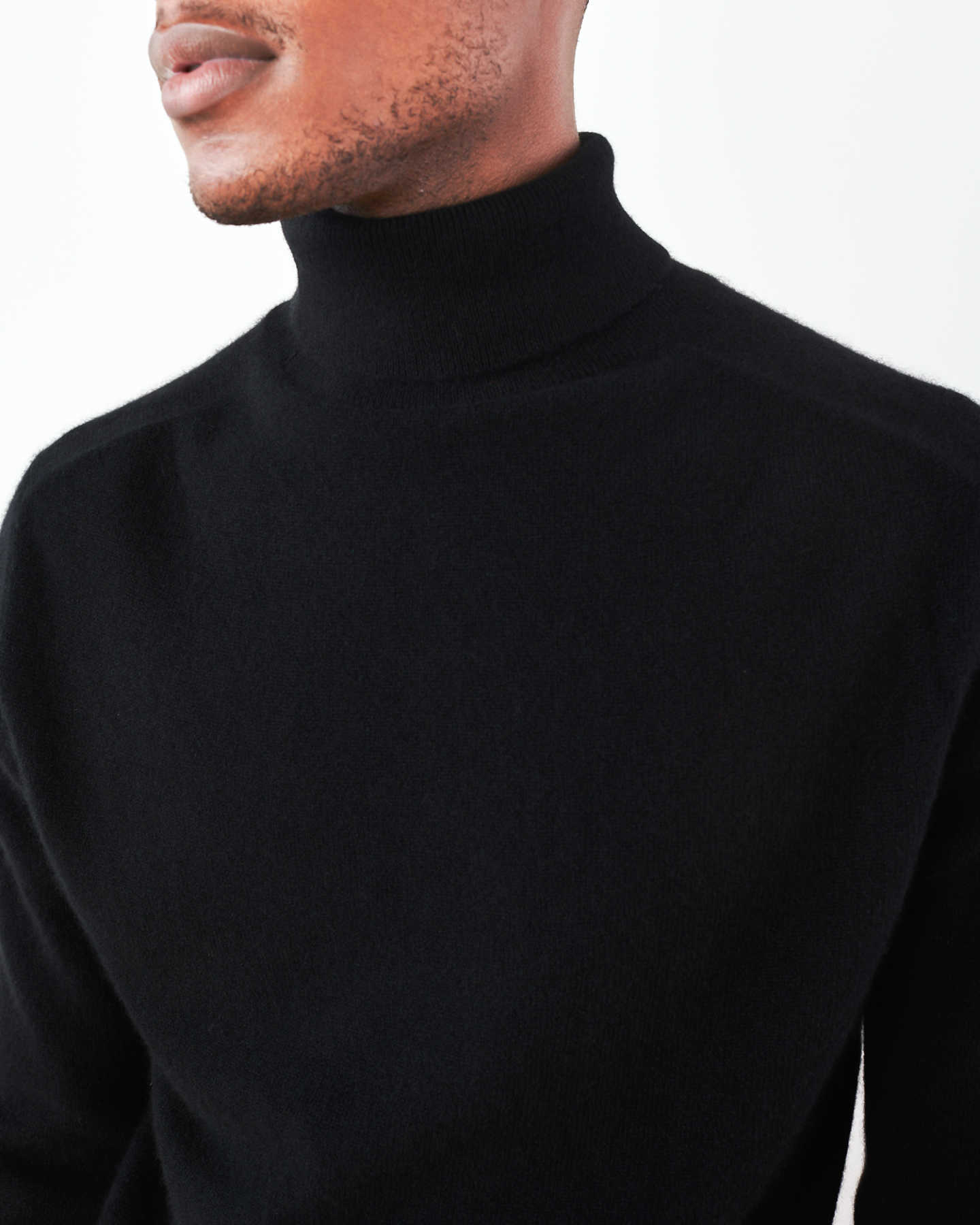 Man wearing men's black cashmere turtleneck sweater zoomed