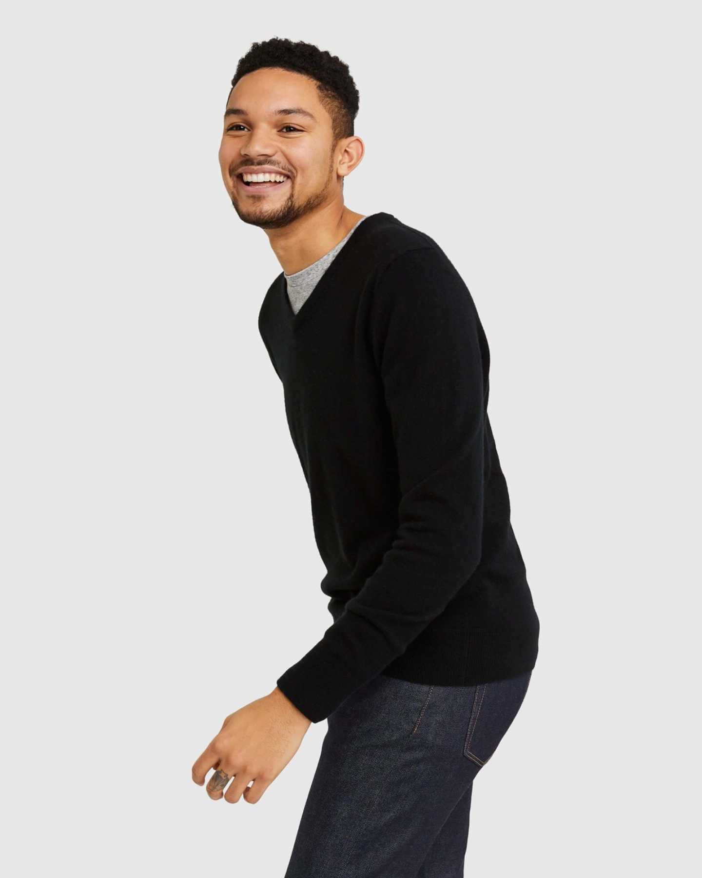 Man wearing black cashmere v-neck sweater for men laughing